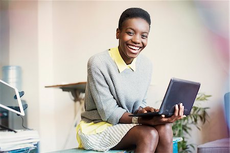 portrait - Portrait smiling businesswoman working with digital tablet Stock Photo - Premium Royalty-Free, Code: 6113-08105322