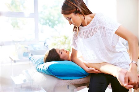 physiotherapy treatment - Masseuse stretching woman's arm Stock Photo - Premium Royalty-Free, Code: 6113-08105447
