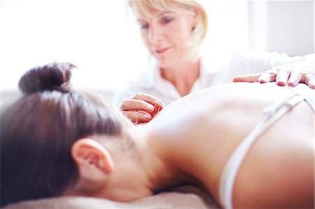 Acupuncturist applying acupuncture needle to woman's neck Stock Photo - Premium Royalty-Free, Code: 6113-08105453