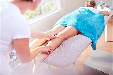 simsearch:6113-08105446,k - Masseuse massaging woman's leg Stock Photo - Premium Royalty-Free, Code: 6113-08105462