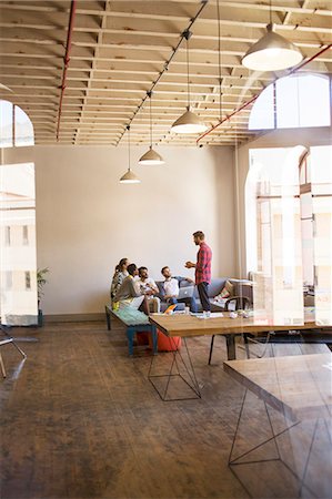 Creative businessman leading meeting in open office Stock Photo - Premium Royalty-Free, Code: 6113-08105439