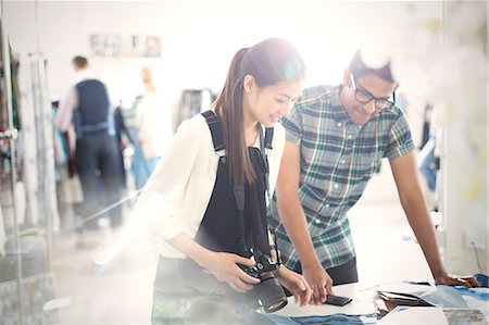 proof - Photographer and fashion designer viewing proofs in sunny office Stock Photo - Premium Royalty-Free, Code: 6113-08220265
