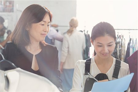 Fashion designer watching assistant taking notes Stock Photo - Premium Royalty-Free, Code: 6113-08220269