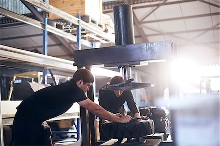 Mechanics fixing tire in auto repair shop Stock Photo - Premium Royalty-Free, Code: 6113-08220201