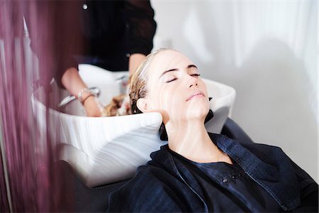 simsearch:649-04249188,k - Customer with eyes closed getting hair washed in salon Stock Photo - Premium Royalty-Free, Code: 6113-08220378