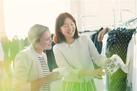 Fashion designers examining cuff detail on blouse Stock Photo - Premium Royalty-Free, Code: 6113-08220320