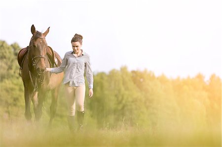 pasture - Woman walking horse in rural field Stock Photo - Premium Royalty-Free, Code: 6113-08220418