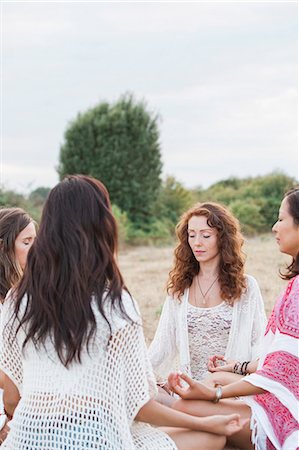 Boho women meditating in circle in rural field Stock Photo - Premium Royalty-Free, Code: 6113-08220545