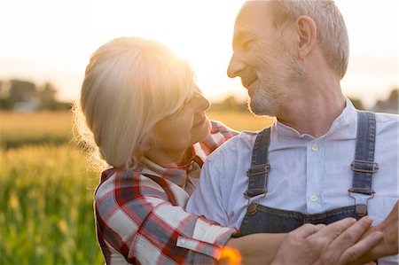 people candid happy - Close up affectionate senior couple hugging in rural field Stock Photo - Premium Royalty-Free, Code: 6113-08220509
