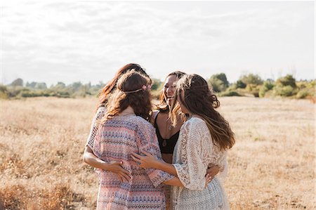 people candid happy - Boho women hugging in rural field Stock Photo - Premium Royalty-Free, Code: 6113-08220531