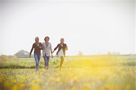 family walk sunshine - Multi-generation women walking in sunny meadow Stock Photo - Premium Royalty-Free, Code: 6113-08393683