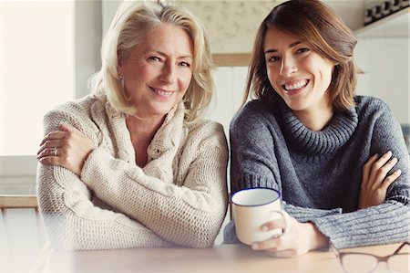 simsearch:6113-08393754,k - Portrait smiling mother and daughter in sweaters drinking coffee in kitchen Stock Photo - Premium Royalty-Free, Code: 6113-08393743