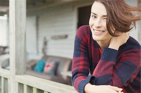 sweaters - Portrait smiling brunette woman on porch Stock Photo - Premium Royalty-Free, Code: 6113-08393754