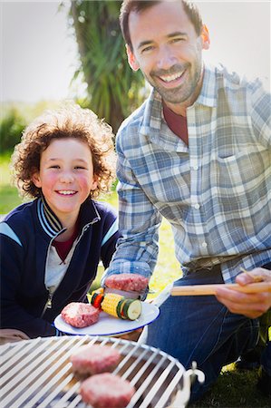 simsearch:6102-08384404,k - Portrait smiling father and son barbecuing Stock Photo - Premium Royalty-Free, Code: 6113-08393708