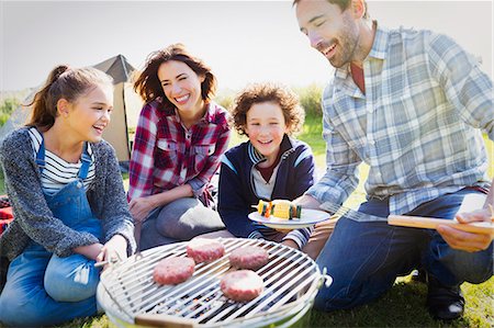 simsearch:6113-08393795,k - Family barbecuing at sunny campsite Stock Photo - Premium Royalty-Free, Code: 6113-08393725