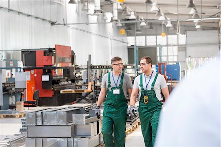 simsearch:6113-08393833,k - Workers walking and talking in factory Stock Photo - Premium Royalty-Free, Code: 6113-08393851