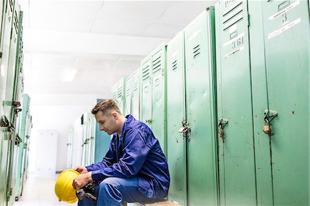 simsearch:6113-06753343,k - Worker holding hard-hat in locker room Stock Photo - Premium Royalty-Free, Code: 6113-08393886