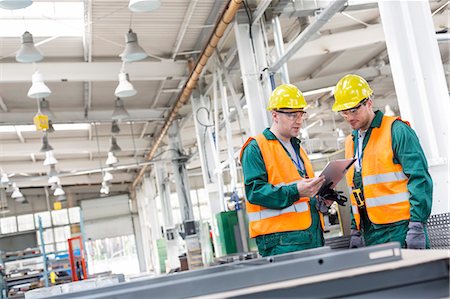 simsearch:6113-09027517,k - Workers in protective workwear with clipboard in factory Stock Photo - Premium Royalty-Free, Code: 6113-08393838