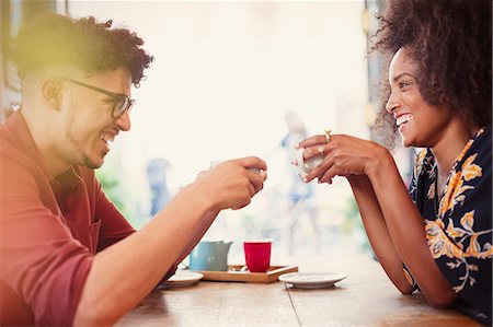 Couple drinking coffee face to face in cafe Stock Photo - Premium Royalty-Free, Code: 6113-08321080