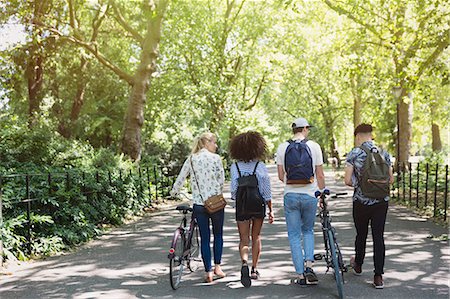 simsearch:6113-07542497,k - Friends walking with bicycles in park Photographie de stock - Premium Libres de Droits, Code: 6113-08321147