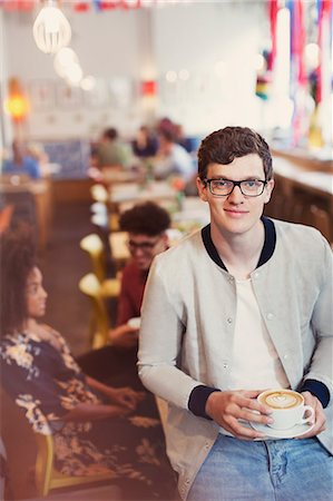 simsearch:6113-08321133,k - Portrait smiling man with eyeglasses drinking cappuccino in cafe Stock Photo - Premium Royalty-Free, Code: 6113-08321144
