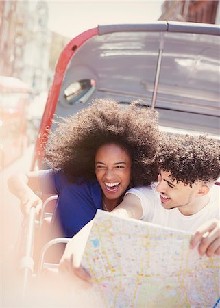 Enthusiastic couple with map on double-decker bus Stock Photo - Premium Royalty-Free, Code: 6113-08321153