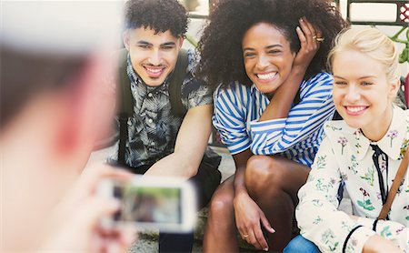 Enthusiastic friends being photographed Stock Photo - Premium Royalty-Free, Code: 6113-08321160