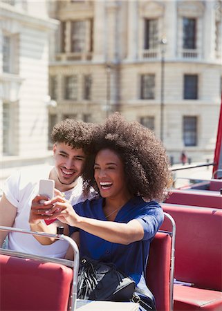 simsearch:6113-07147999,k - Couple taking selfie on double-decker bus Photographie de stock - Premium Libres de Droits, Code: 6113-08321172