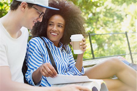 simsearch:6113-08321133,k - College students drinking coffee and studying in park Stock Photo - Premium Royalty-Free, Code: 6113-08321175