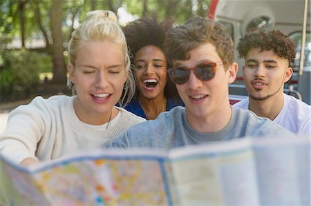 Friends looking at map on double-decker bus Stock Photo - Premium Royalty-Free, Code: 6113-08321194