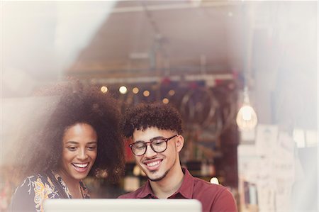 Couple using laptop in cafe window Stock Photo - Premium Royalty-Free, Code: 6113-08321129