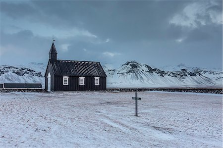 faith - Church and graveyard in snowy remote mountain landscape, Budir, Snaefellsnes, Iceland Stock Photo - Premium Royalty-Free, Code: 6113-08321252
