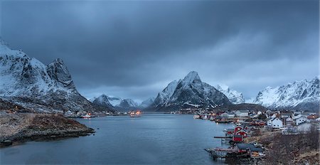 simsearch:6122-07704263,k - Snow covered mountain range above fishing village at dusk, Reine, Lofoten Islands, Norway Stock Photo - Premium Royalty-Free, Code: 6113-08321258