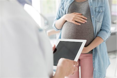 simsearch:6113-08105459,k - Doctor with digital tablet talking to pregnant patient Stock Photo - Premium Royalty-Free, Code: 6113-08321315