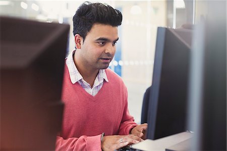 simsearch:6113-08321440,k - Man typing at computer in adult education classroom Stock Photo - Premium Royalty-Free, Code: 6113-08321446