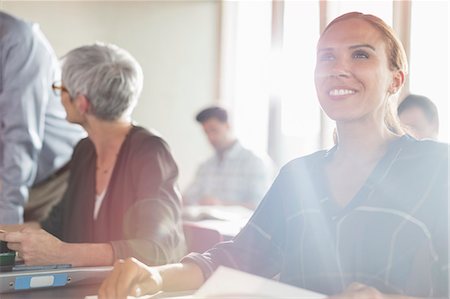 simsearch:6113-07243319,k - Smiling woman in sunny adult education workshop Stock Photo - Premium Royalty-Free, Code: 6113-08321482