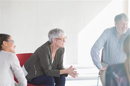 sitting circle - Smiling business people in meeting Stock Photo - Premium Royalty-Free, Code: 6113-08321493