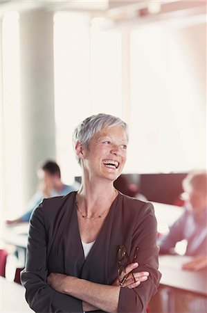 students laughing - Laughing senior woman in adult education classroom Stock Photo - Premium Royalty-Free, Code: 6113-08321423