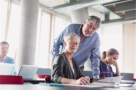 Students discussing homework in adult education classroom Stock Photo - Premium Royalty-Free, Code: 6113-08321439