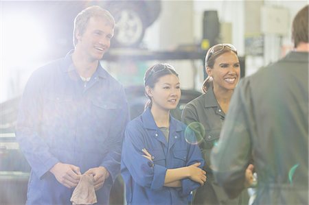 Mechanics listening in auto repair shop Stock Photo - Premium Royalty-Free, Code: 6113-08321552