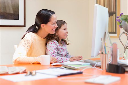 Mother and daughter using computer Stock Photo - Premium Royalty-Free, Code: 6113-08321584