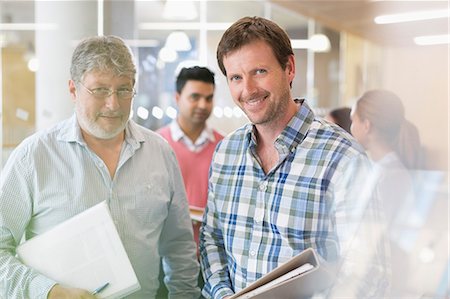 portrait two colleagues - Portrait confident businessmen with notebooks Stock Photo - Premium Royalty-Free, Code: 6113-08321502