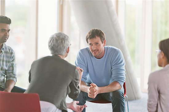 Business people talking in group meeting Stock Photo - Premium Royalty-Free, Image code: 6113-08321508