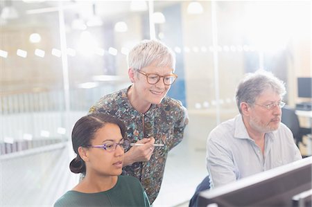 picture of student helping teacher - Businesswomen working at computer in office Stock Photo - Premium Royalty-Free, Code: 6113-08321527