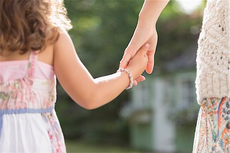 people together candid not office - Close up rear view mother and daughter holding hands Stock Photo - Premium Royalty-Free, Code: 6113-08321649