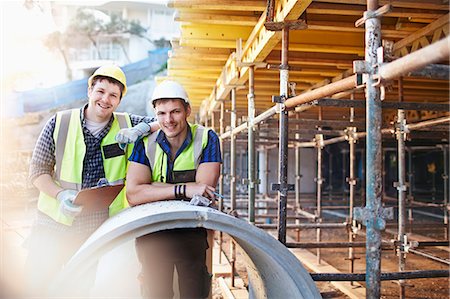 smiling engineer portrait - Portrait confident engineers with clipboard at construction site Stock Photo - Premium Royalty-Free, Code: 6113-08321742