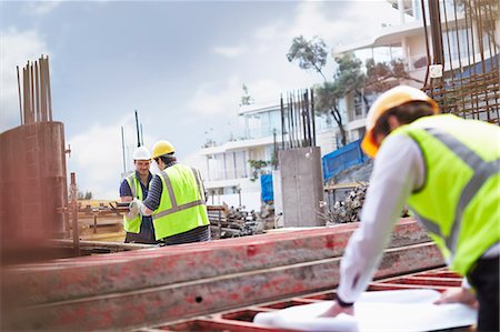 Engineer reviewing blueprints at construction site Stock Photo - Premium Royalty-Free, Code: 6113-08321753