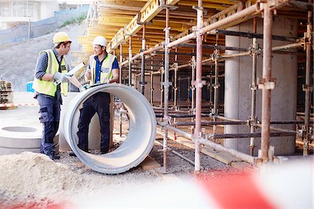 simsearch:6113-08321753,k - Construction workers talking at construction site Stock Photo - Premium Royalty-Free, Code: 6113-08321750