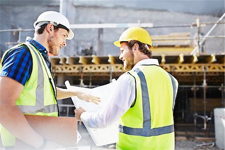 reviewing blueprints - Construction worker and engineer reviewing blueprints at construction site Stock Photo - Premium Royalty-Free, Code: 6113-08321754