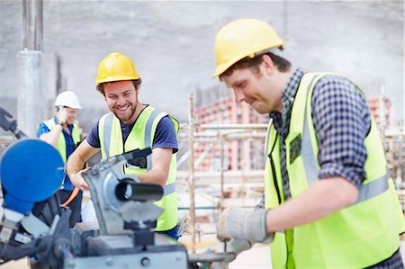 simsearch:6113-08321753,k - Construction workers using equipment at construction site Stock Photo - Premium Royalty-Free, Code: 6113-08321763